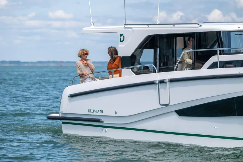 Slide: The Image of 2025 Delphia D10 Sedan cruising on open water with passengers enjoying the view. - 3