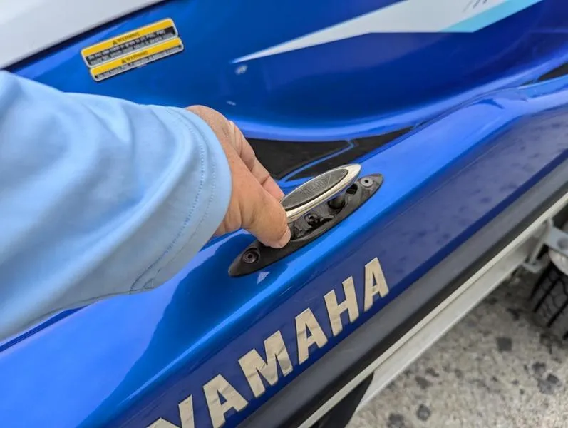 Slide: The Image of 2022 Yamaha WaveRunner EX LIMITED GP 1800, blue exterior, hand adjusting cleat. - 12