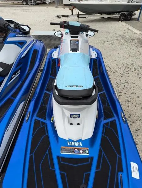 Slide: The Image of 2022 Yamaha WaveRunner EX LIMITED GP 1800 jet ski, blue and white, parked on gravel. - 3