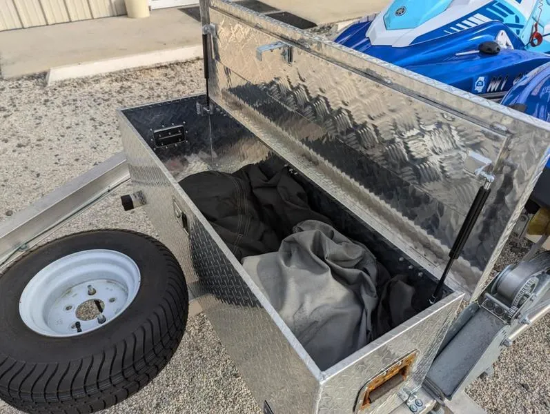 Slide: The Image of Open storage box on trailer with spare tire, next to 2022 Yamaha WaveRunner EX LIMITED GP 1800. - 5