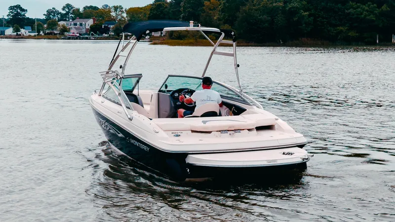 Slide: The Image of 2020 Crownline 290 SS boat side view with logo and sleek design. - 2