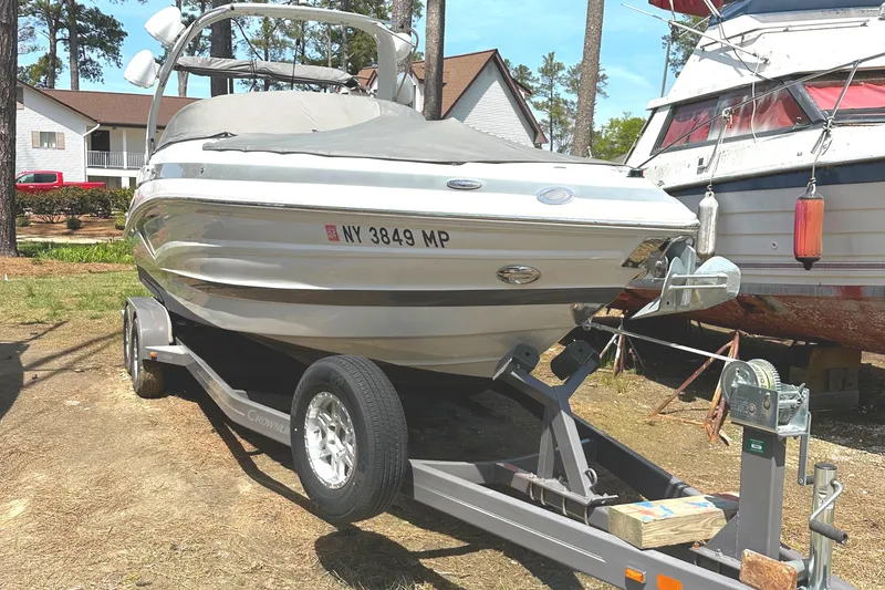 Slide: The Image of 2020 Crownline 290 SS boat interior with white cushioned seating. - 32