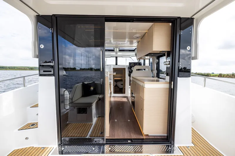 Slide: The Image of 2025 Delphia D10 Sedan interior with modern design, featuring sleek cabinetry and spacious seating. - 10