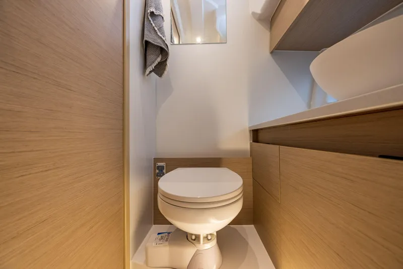 Slide: The Image of 2025 Delphia D10 Sedan bathroom with modern design and compact toilet. - 18