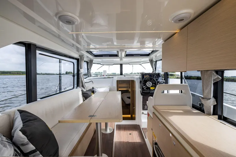 Slide: The Image of Interior of 2025 Delphia D10 Sedan boat with modern seating and navigation area. - 7