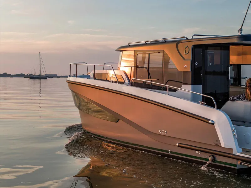 Slide: The Image of 2025 Delphia D10 Sedan cruising on calm waters at sunset. - 4