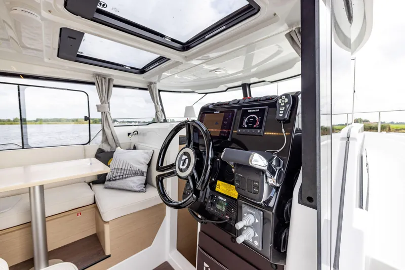 Slide: The Image of 2025 Delphia D10 Sedan interior with modern helm, seating, and panoramic windows. - 6