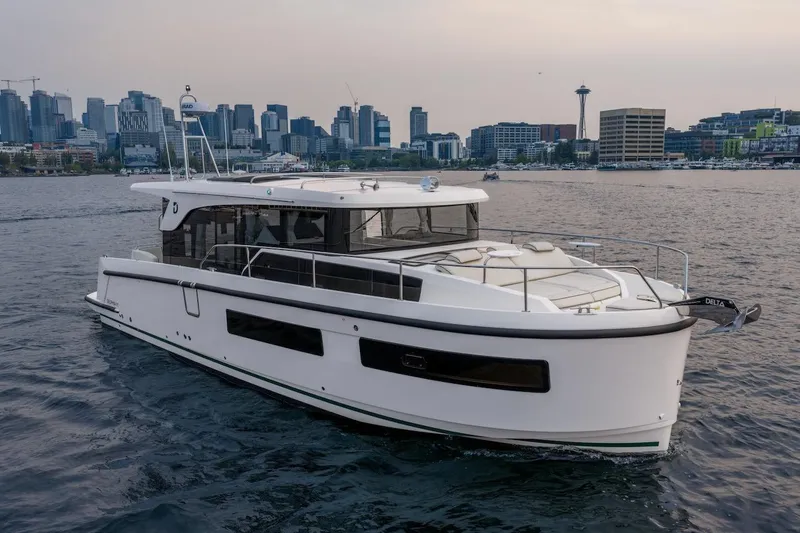 Slide: The Image of 2025 Delphia D11 SEDAN yacht cruising near a city skyline at sunset. - 17