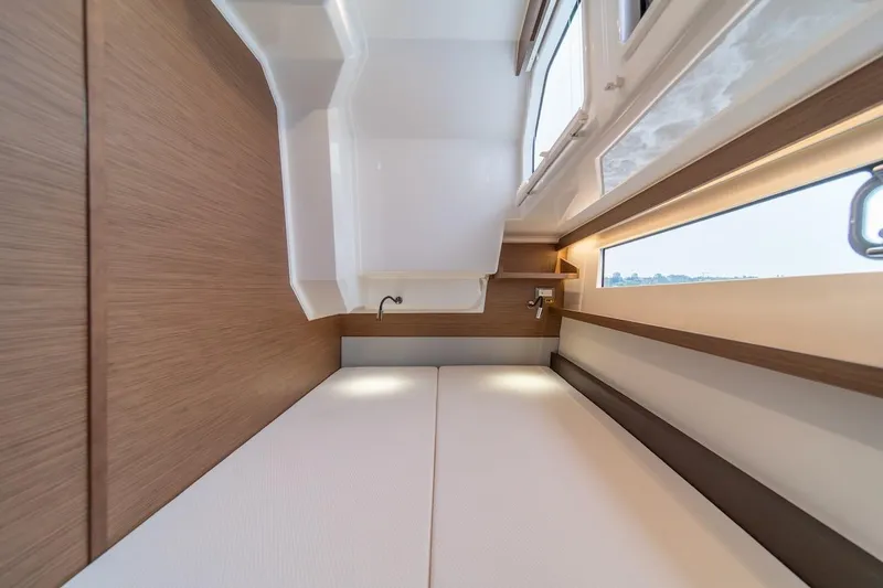 Slide: The Image of Interior cabin of 2025 Delphia D11 SEDAN yacht, featuring modern wood paneling and sleek design. - 23