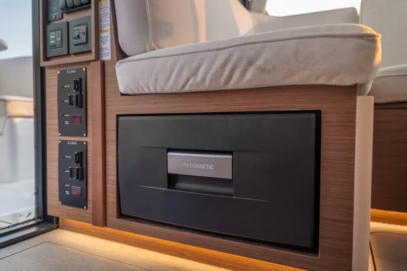 Slide: The Image of Interior of 2025 Delphia D11 SEDAN featuring Dometic appliance and control panels. - 36