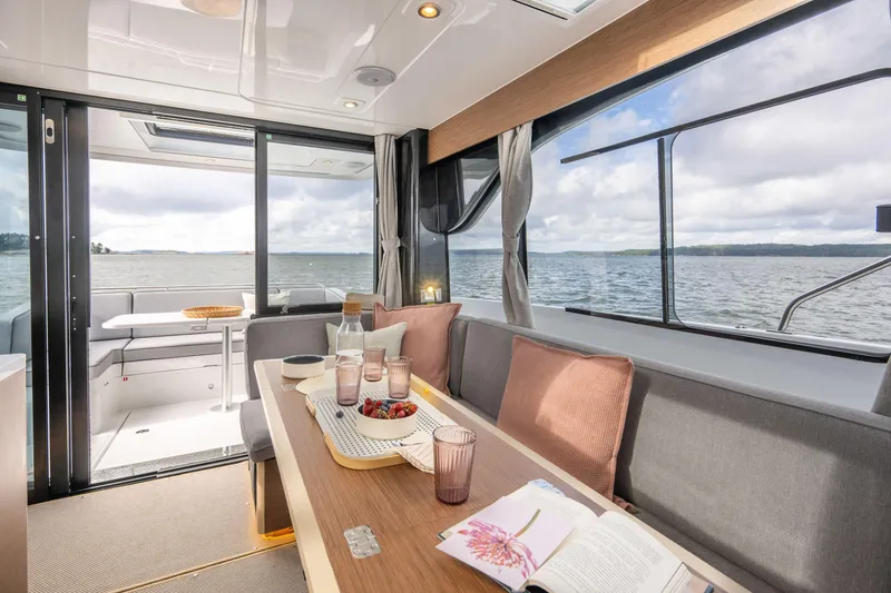 Slide: The Image of Interior of 2025 Delphia D11 Sedan yacht with dining area and sea view. - 6