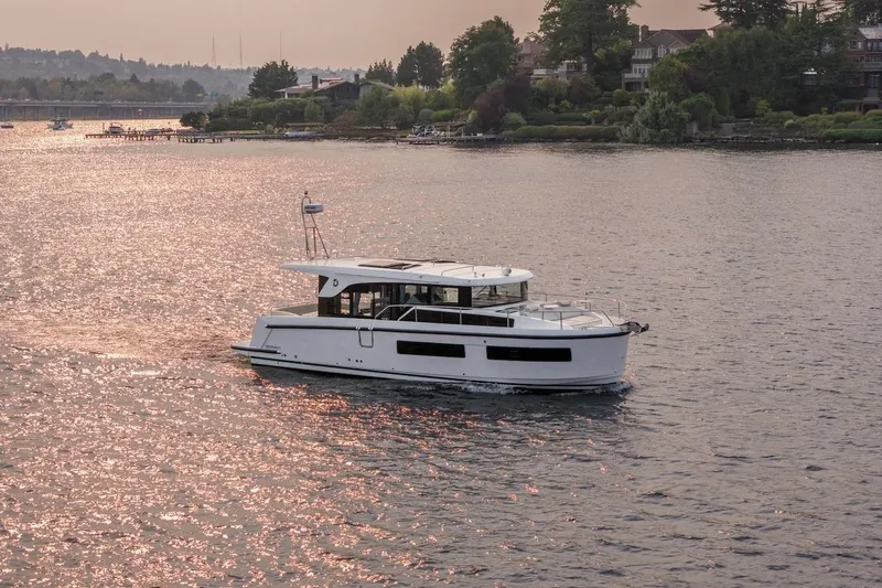 Slide: The Image of 2025 Delphia D11 SEDAN cruising on a serene lake at sunset. - 18