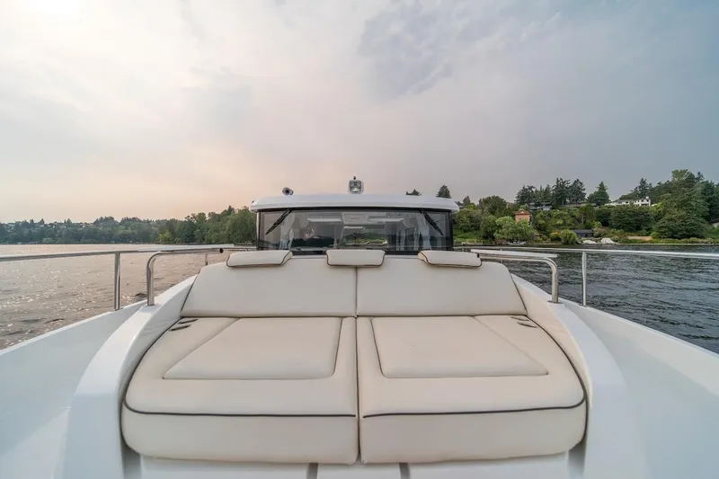 Slide: The Image of Luxurious 2025 Delphia D11 SEDAN yacht with spacious deck, cruising on a serene lake. - 10