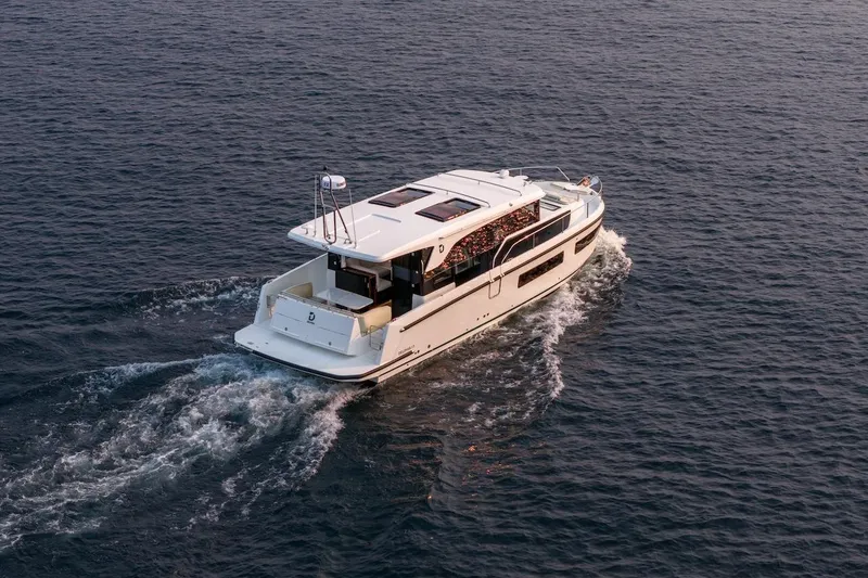 Slide: The Image of 2025 Delphia D11 SEDAN cruising on open water at sunset. - 15