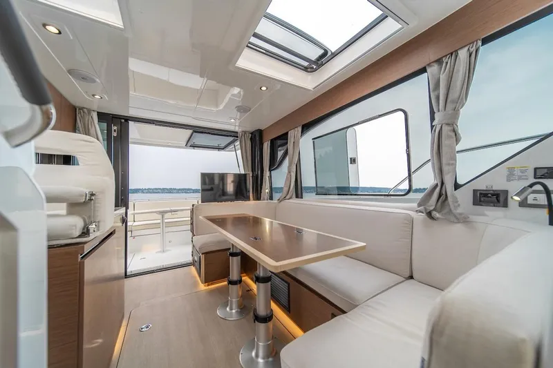 Slide: The Image of Luxurious interior of 2025 Delphia D11 SEDAN yacht with modern seating and panoramic windows. - 30