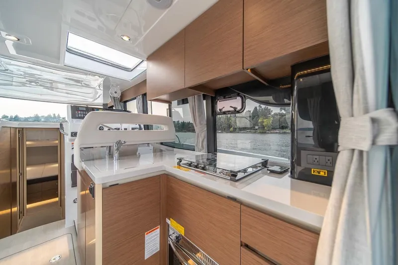 Slide: The Image of Interior of 2025 Delphia D11 SEDAN yacht with modern kitchen and scenic window view. - 34