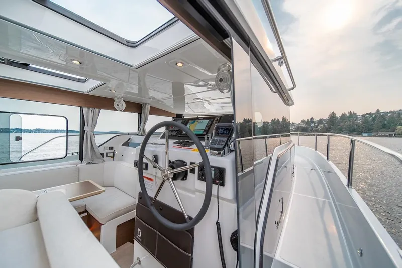 Slide: The Image of Interior view of 2025 Delphia D11 SEDAN yacht with modern helm and seating. - 35