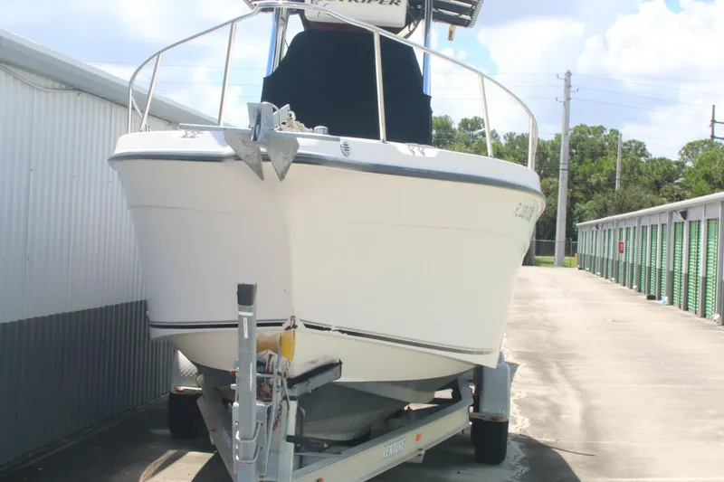 Slide: The Image of 2006 Seaswirl Striper 2601 boat on trailer, parked outdoors near storage units. - 11