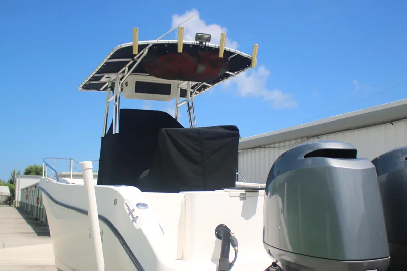 Slide: The Image of 2006 Seaswirl Striper 2601 boat with dual outboard motors, docked under clear blue sky. - 12