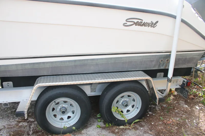 Slide: The Image of 2006 Seaswirl Striper 2601 boat on trailer, side view with dual wheels. - 17