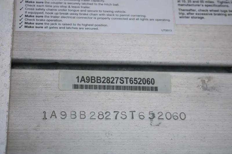 Slide: The Image of VIN plate of a 2006 Seaswirl Striper 2601 boat with safety instructions. - 19