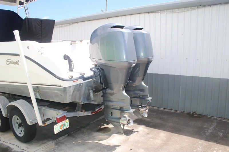 Slide: The Image of 2006 Seaswirl Striper 2601 boat with dual outboard motors on a trailer. - 2