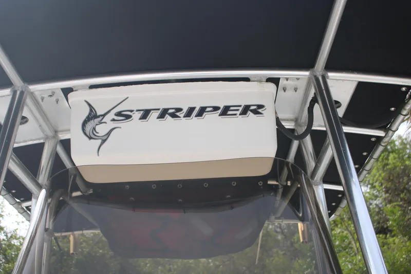 Slide: The Image of 2006 Seaswirl Striper 2601 boat with logo on canopy, featuring sleek design. - 20