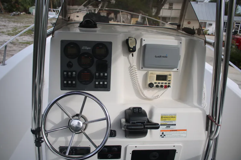 Slide: The Image of 2006 Seaswirl Striper 2601 boat dashboard with Garmin navigation system and steering wheel. - 29