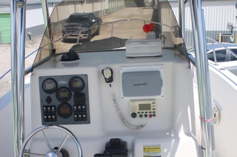 Slide: The Image of 2006 Seaswirl Striper 2601 boat dashboard with steering wheel and navigation instruments. - 9
