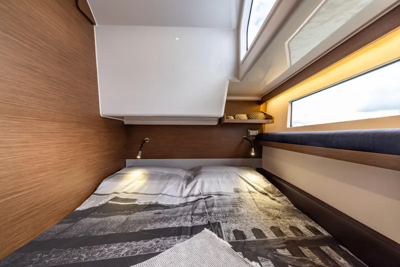 Slide: The Image of 2025 Delphia D11 Flybridge cabin interior with cozy bed and modern lighting. - 12
