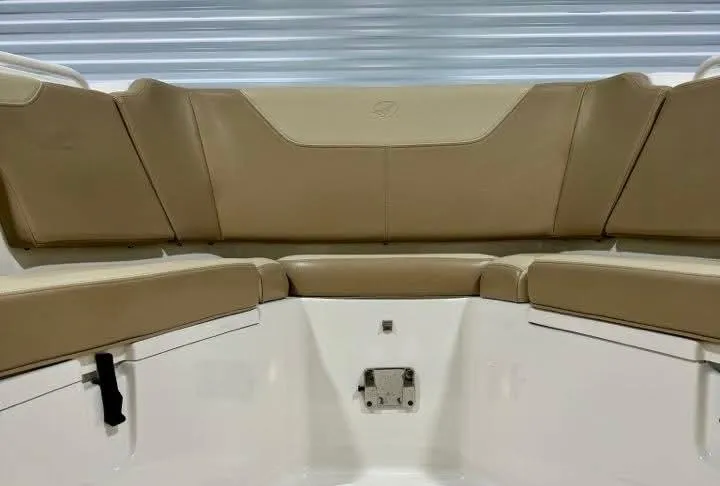 Slide: The Image of 2018 Sailfish 325 DC boat interior with tan seating and white accents. - 11