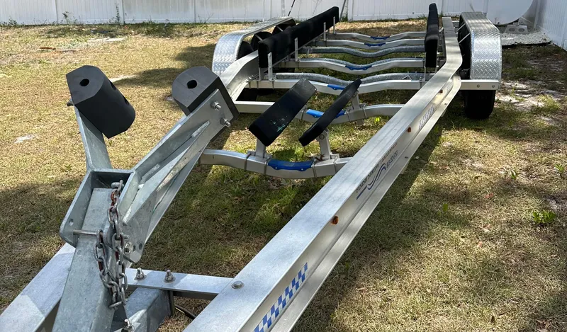 Slide: The Image of Boat trailer for 2018 Sailfish 325 DC on grass, ready for transport. - 19