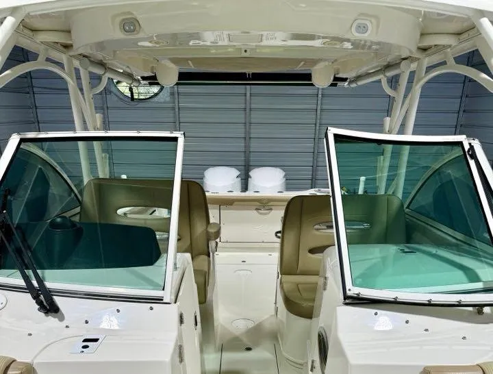 Slide: The Image of 2018 Sailfish 325 DC boat interior with dual consoles and seating. - 7