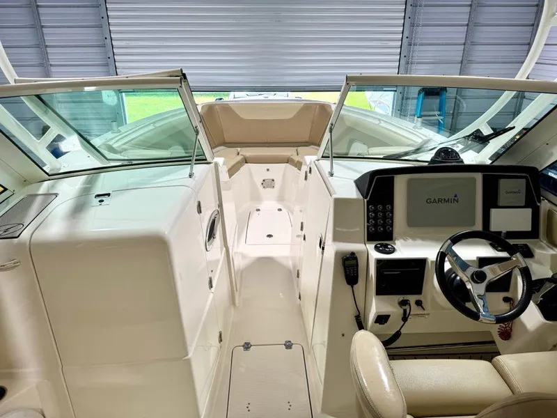 Slide: The Image of 2018 Sailfish 325 DC boat interior with Garmin navigation system and dual console design. - 9