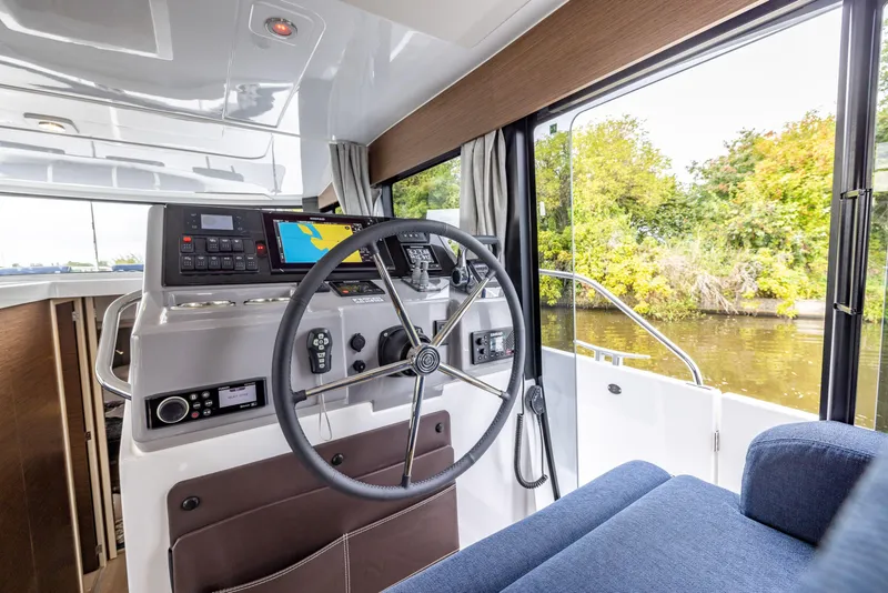 Slide: The Image of Interior view of 2025 Delphia D11 Flybridge boat with steering wheel and navigation equipment. - 10
