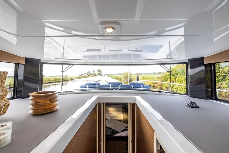 Slide: The Image of 2025 Delphia D11 Flybridge interior with panoramic windows and modern design. - 6