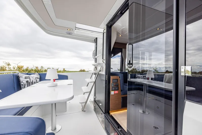 Slide: The Image of 2025 Delphia D11 Flybridge yacht with sleek interior, outdoor seating, and modern design. - 8