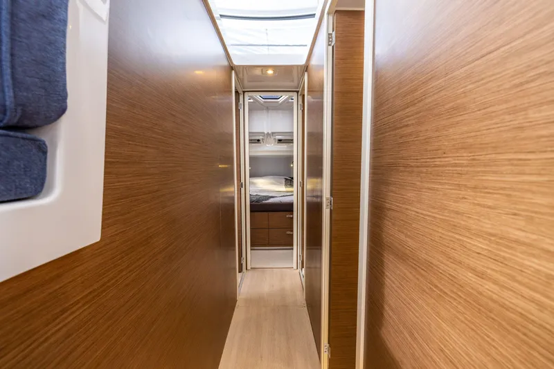 Slide: The Image of 2025 Delphia D11 Flybridge interior hallway with wood paneling and natural light. - 14