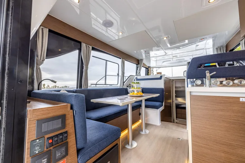 Slide: The Image of 2025 Delphia D11 Flybridge interior with modern seating, dining area, and control panel. - 5