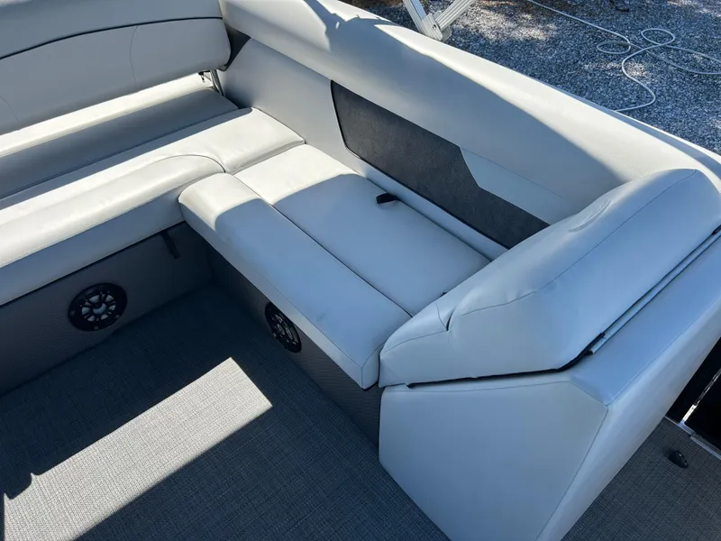 Slide: The Image of 2021 Crest 240 LX SLSC boat interior with gray seating and speaker system. - 11