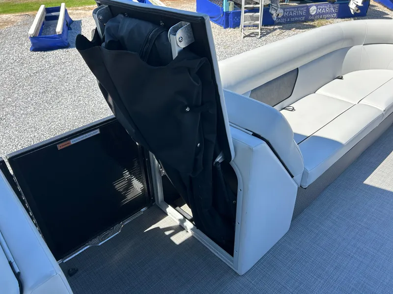 Slide: The Image of 2021 Crest 240 LX SLSC boat interior with storage compartment and seating. - 15