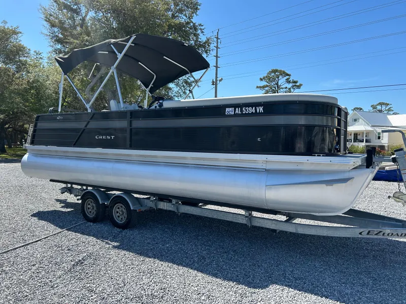 Slide: The Image of 2021 Crest 240 LX SLSC pontoon boat on trailer, parked outdoors. - 4