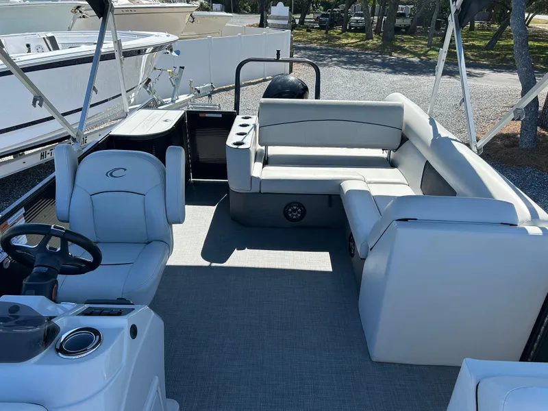 Slide: The Image of 2021 Crest 240 LX SLSC pontoon boat interior with seating and steering console. - 8