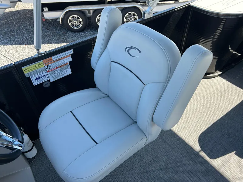 Slide: The Image of 2021 Crest 240 LX SLSC boat seat with logo, gray upholstery, and armrests. - 9