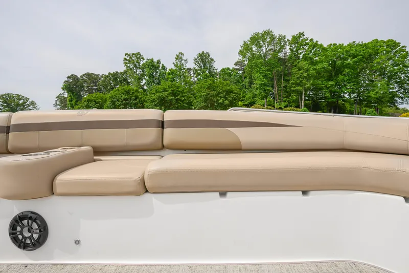 Slide: The Image of Beige seating on 2022 Hurricane SS201 boat with lush green trees in background. - 10