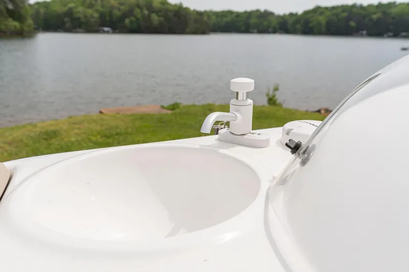 Slide: The Image of Boat sink on Hurricane SS201, 2022 model, with lake view in the background. - 11
