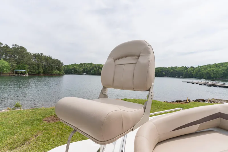 Slide: The Image of Boat seat on a 2022 Hurricane SS201, overlooking a serene lake and lush greenery. - 13