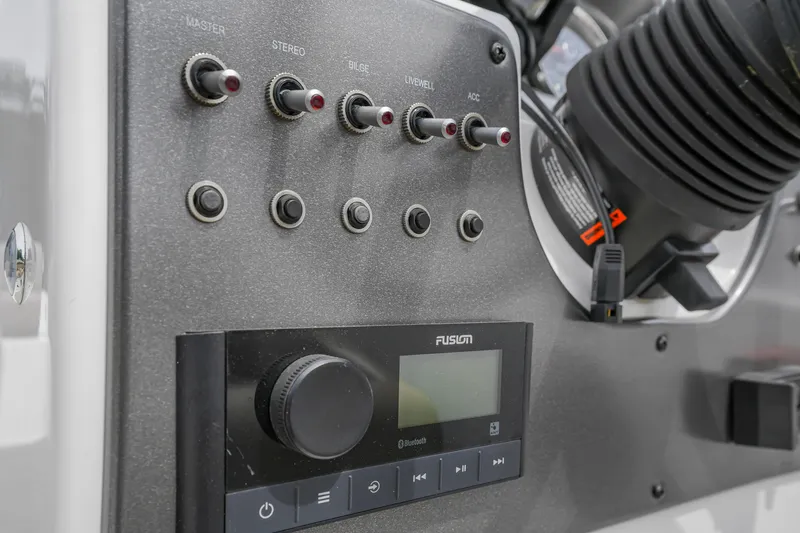 Slide: The Image of Control panel of 2022 Hurricane SS201 boat with switches and Fusion audio system. - 14
