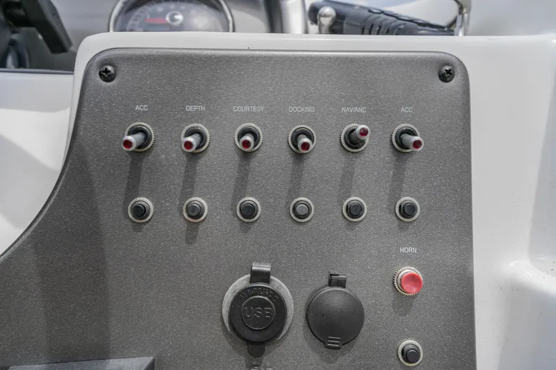 Slide: The Image of Control panel of a 2022 Hurricane SS201 boat with various switches and buttons. - 15