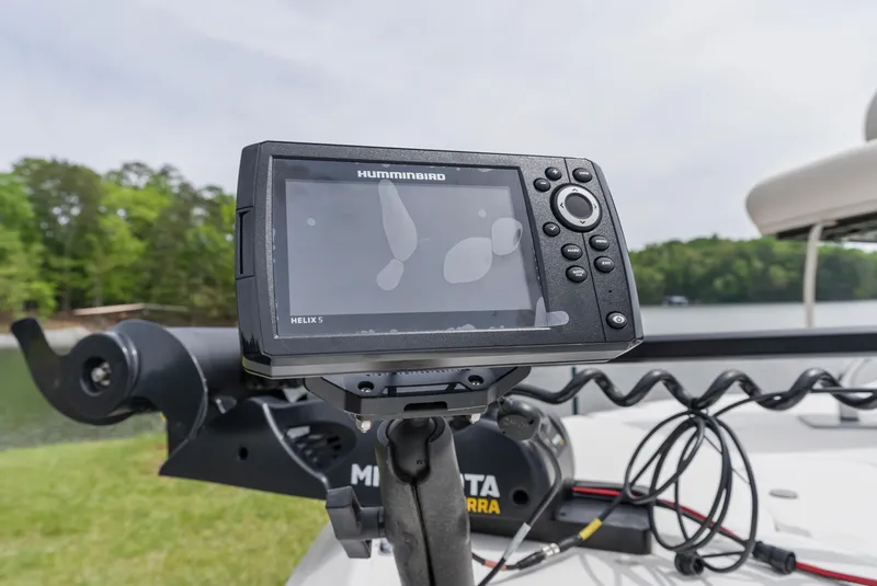 Slide: The Image of Fishfinder on a 2022 Hurricane SS201 boat, near a lake with trees in the background. - 20